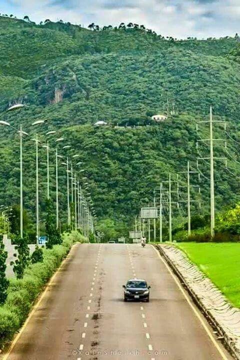 transportation, road, the way forward, tree, road marking, diminishing perspective, country road, land vehicle, vanishing point, car, mode of transport, sky, mountain, grass, street, green color, empty road, nature, growth, landscape