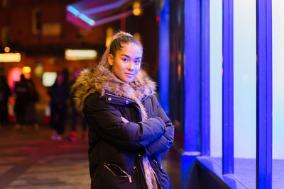 Young woman standing in snow