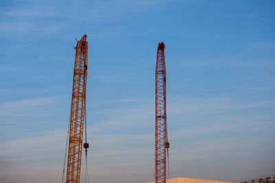 Low angle view of crane against sky