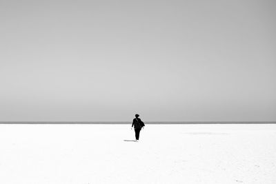 Full length of man standing on snow covered land