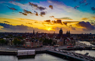 View of buildings at waterfront during sunset