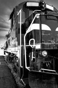 Train on old railroad tracks against sky