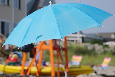 Close-up of wet blue umbrella in rainy season