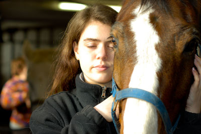 Portrait of teenage girl in stable