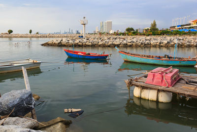 Boats moored on river against sky