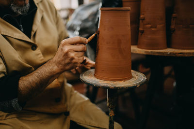 Midsection of man working at workshop