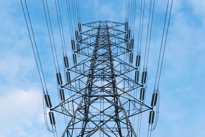 Low angle view of electricity pylon against sky