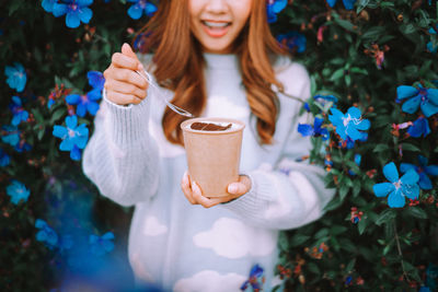 Portrait of young woman drinking coffee