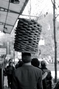 Rear view of man carrying buns on head