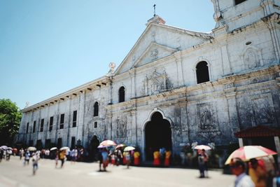 Group of people in front of historic building