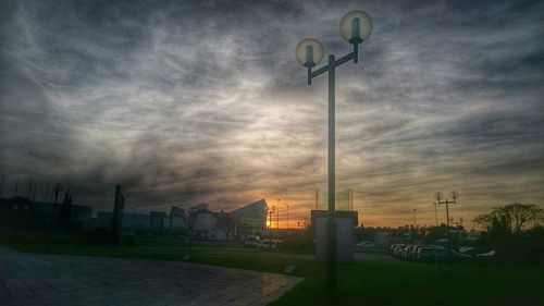 Street light against cloudy sky