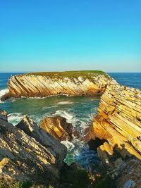 Scenic view of sea against clear blue sky