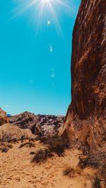 Scenic view of mountains against blue sky