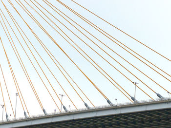 Low angle view of suspension bridge against clear sky