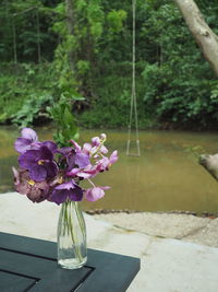 Close-up of purple flower in vase on table