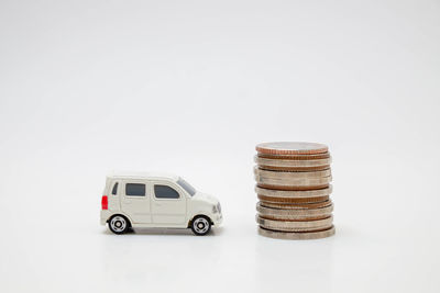 Stack of toy car against white background