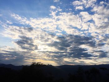 Low angle view of silhouette mountain against dramatic sky