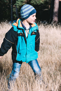 Boy on grassy field during winter