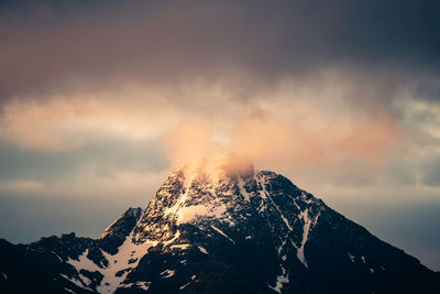 Scenic view of snowcapped mountains against sky during sunset