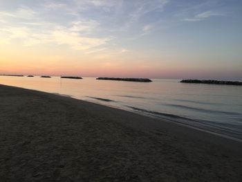 Scenic view of beach against sky during sunset