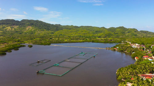 Fish farm with ponds and nets among the mountains covered with philippines.