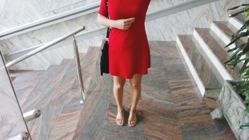 Close-up of woman standing on tiled floor