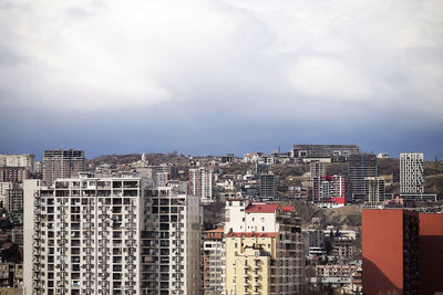 A cityscape with dramatic sky