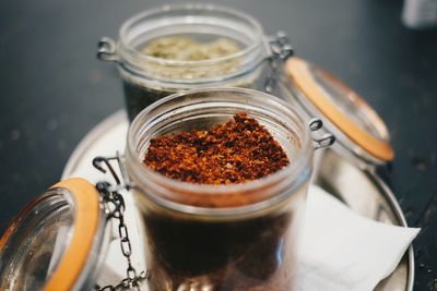 High angle view of spices in jars on table