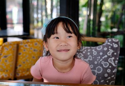 Portrait of cute girl smiling at table