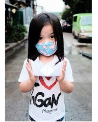 Portrait of cute girl wearing mask standing outdoors