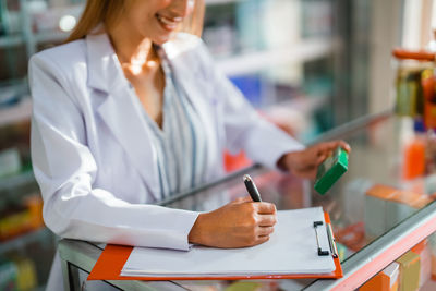 Midsection of businesswoman working in office