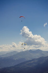 People paragliding against sky