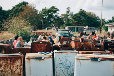 Rusty objects in city against trees