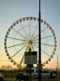 Low angle view of ferris wheel against sky