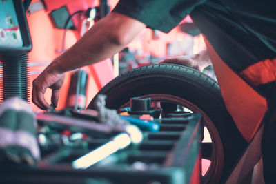 Midsection of man repairing car