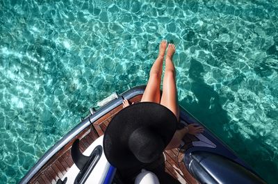 Directly above shot of woman sitting in boat on sea