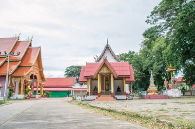 Temple amidst buildings against sky