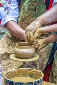 Midsection of woman working in mud