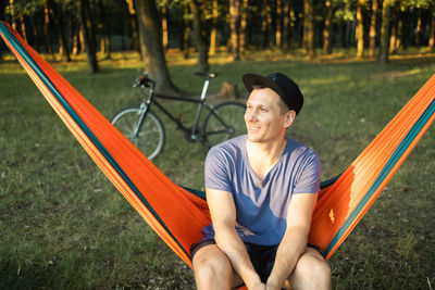 Portrait of young woman sitting on hammock