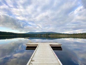 Pier on lake against sky