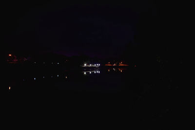 Illuminated built structure against sky at night