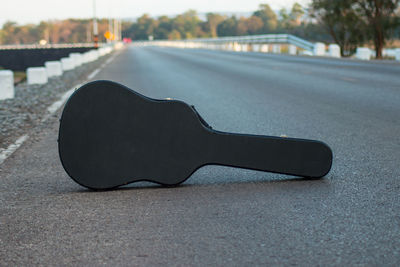 Guitar case on road