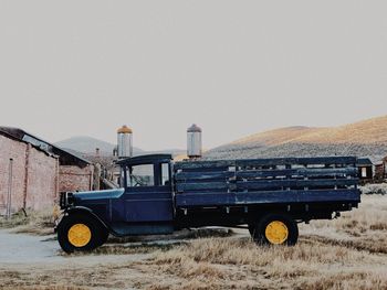 Truck on field against clear sky