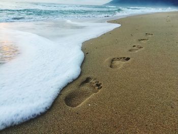 High angle view of footprints on beach