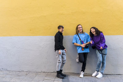 Young diverse friends talking outdoors on the street.