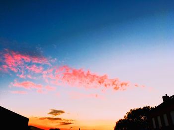 Low angle view of silhouette trees against sky