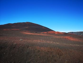 Scenic view of mountains against clear blue sky