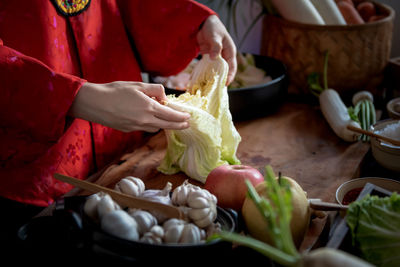 Midsection of person preparing food