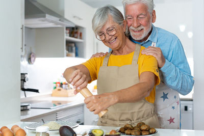 Portrait of senior male dentist in kitchen