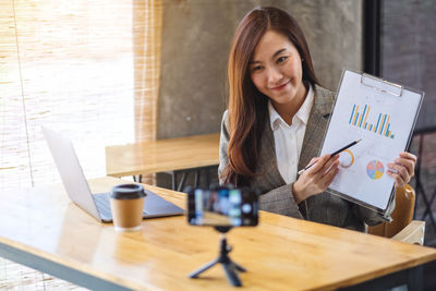 Portrait of businesswoman working at desk in office